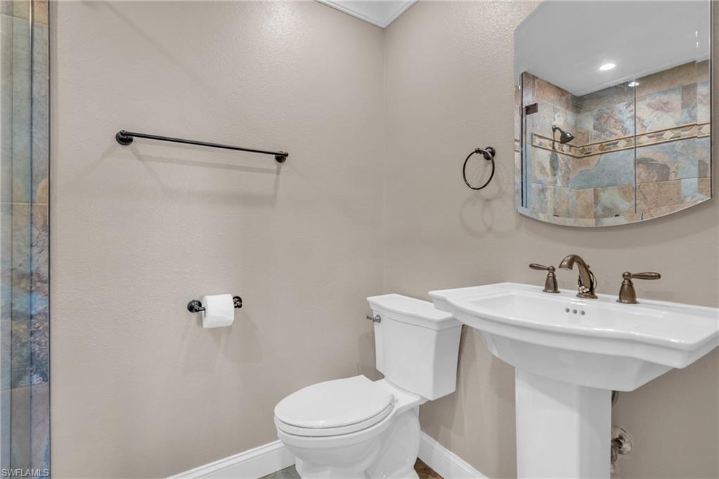 3001 50th Street Southwest Naples, FL 34116 - Photo 19 of 46 a bathroom with a sink a toilet and shower