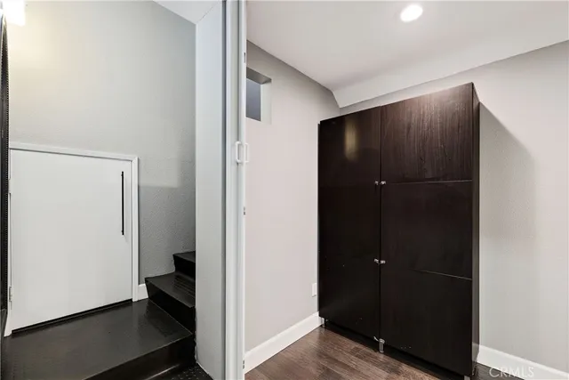 a bedroom with furniture and a wooden floor