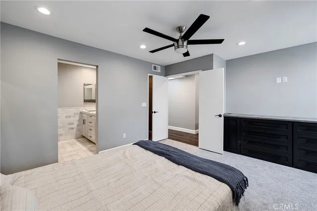 a bedroom with a bed and a dresser