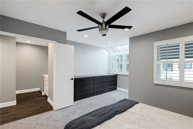 a living room with a bed and a window