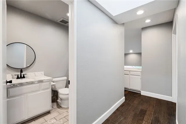 a bathroom with a sink toilet and a mirror