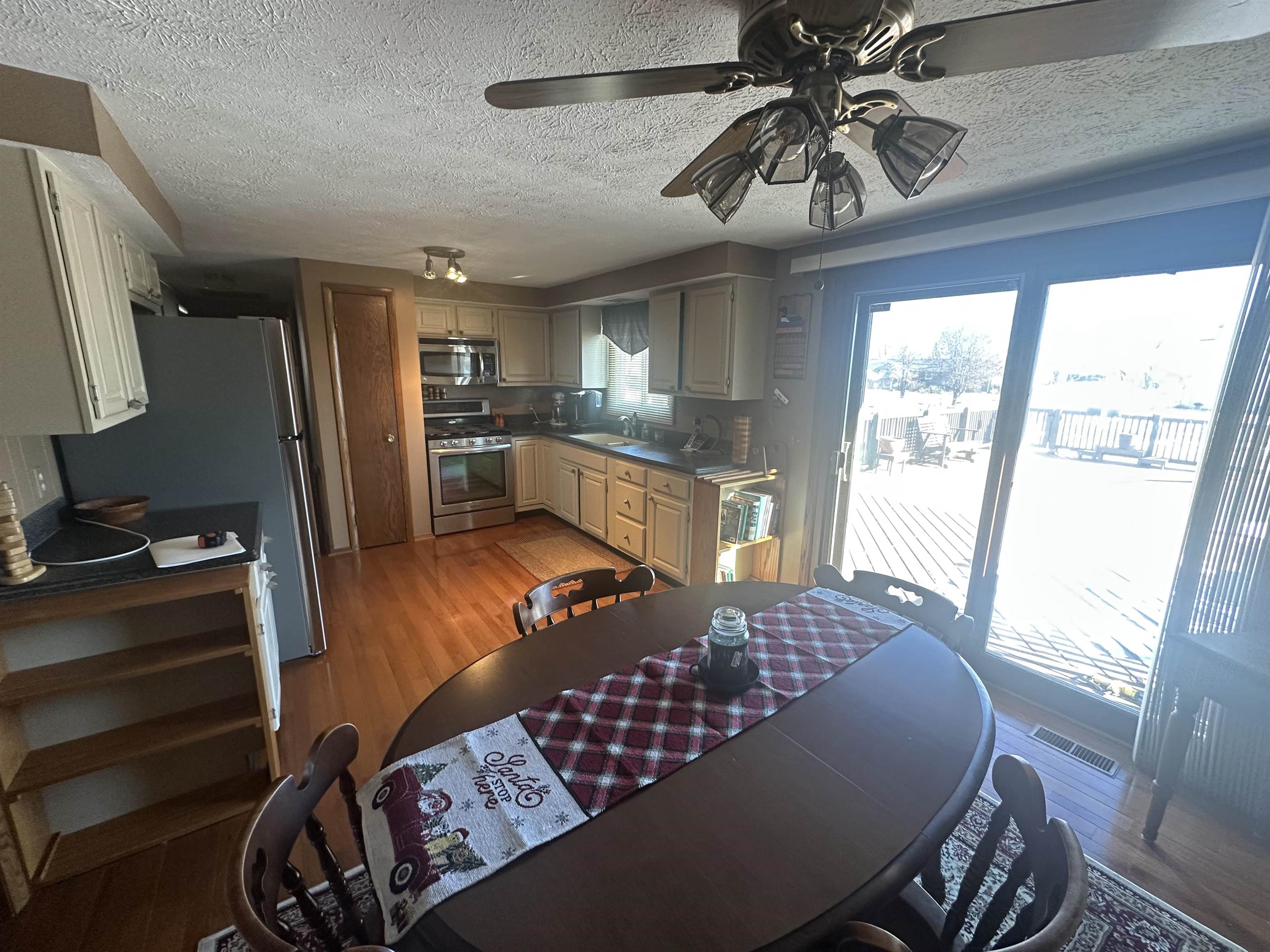 7232 Ralph Road Rockford, IL 61109 - Photo 5 of 20 a living room with furniture a flat screen tv and a large window