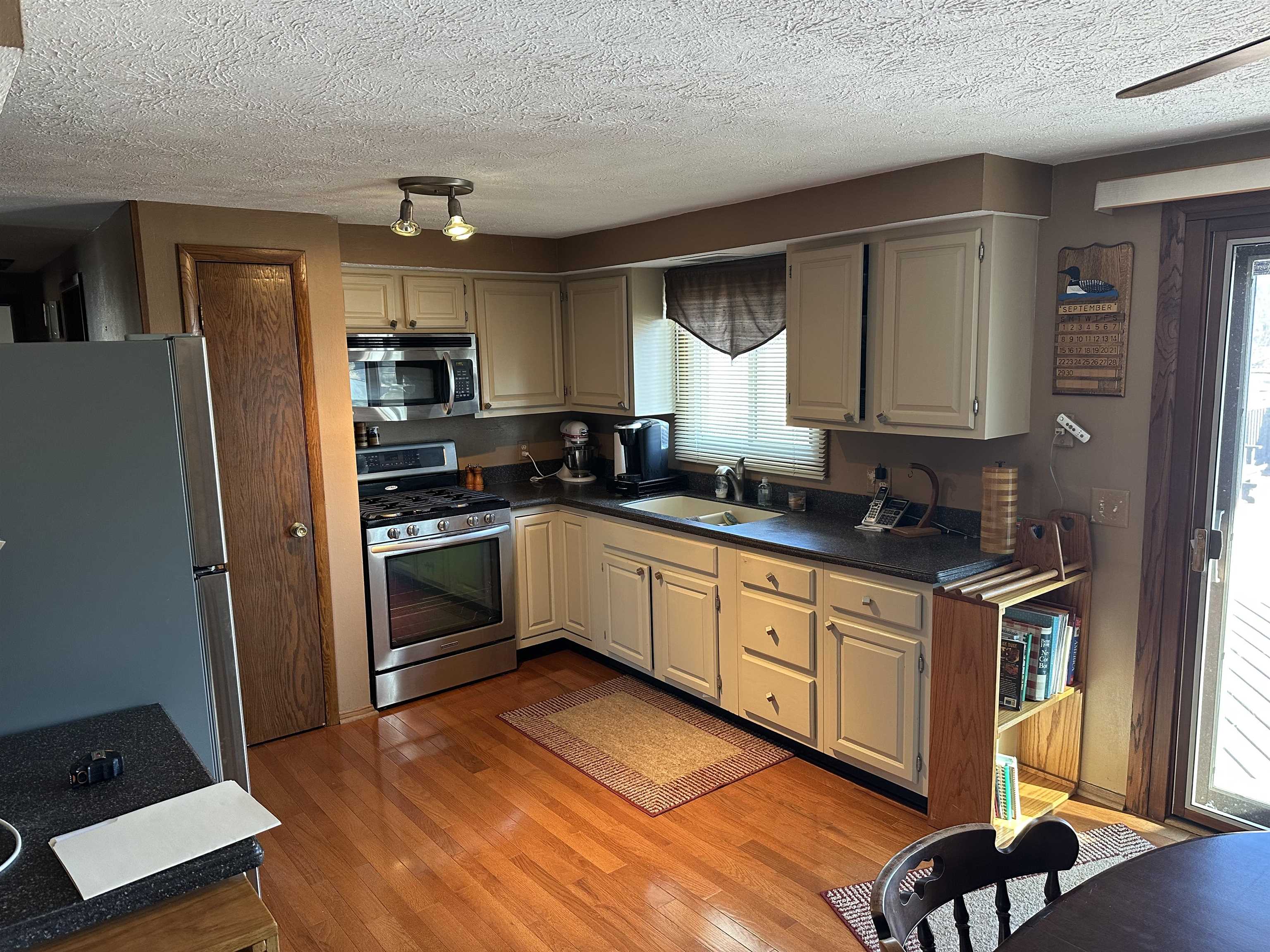 7232 Ralph Road Rockford, IL 61109 - Photo 8 of 20 a kitchen with stainless steel appliances granite countertop a refrigerator and a stove top oven