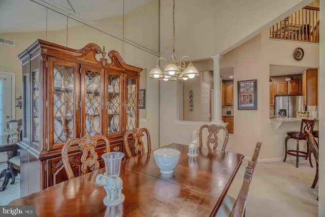 a view of a dining room with furniture and chandelier