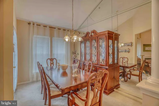 a view of a dining room with furniture and chandelier