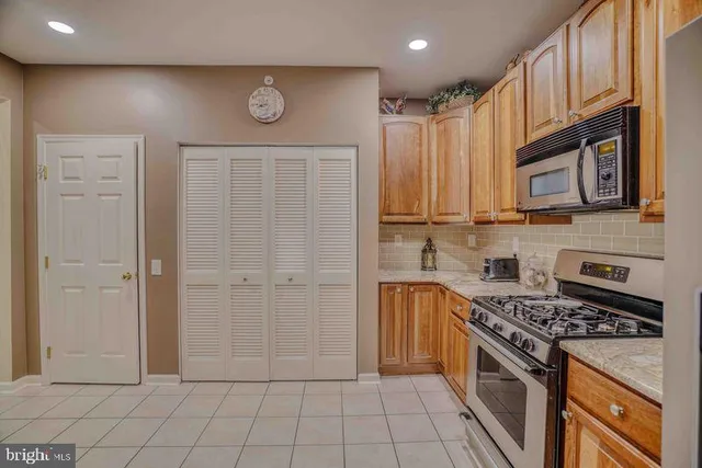 a kitchen with stainless steel appliances granite countertop a stove and a refrigerator