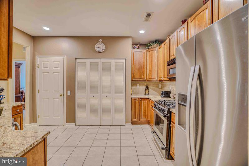 200 Beech Boulevard, Unit 301 Warrington, PA 18976 - Photo 19 of 42 a kitchen with stainless steel appliances granite countertop a refrigerator and a stove