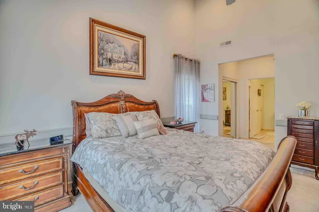 a bedroom with a bed and a dresser in it