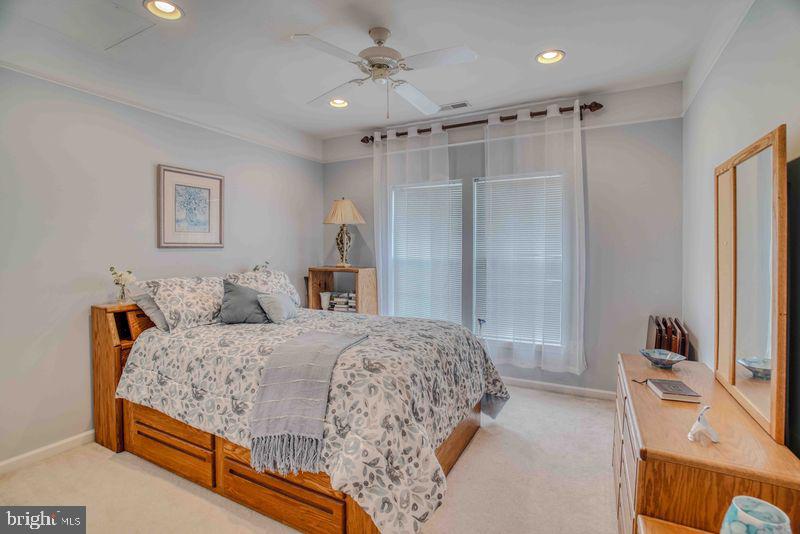 200 Beech Boulevard, Unit 301 Warrington, PA 18976 - Photo 29 of 42 a bedroom with a bed and a mirror