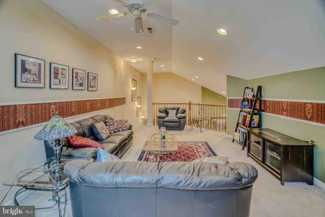 a living room with furniture a air conditioner and a table