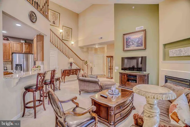 a living room with furniture kitchen view and a fireplace