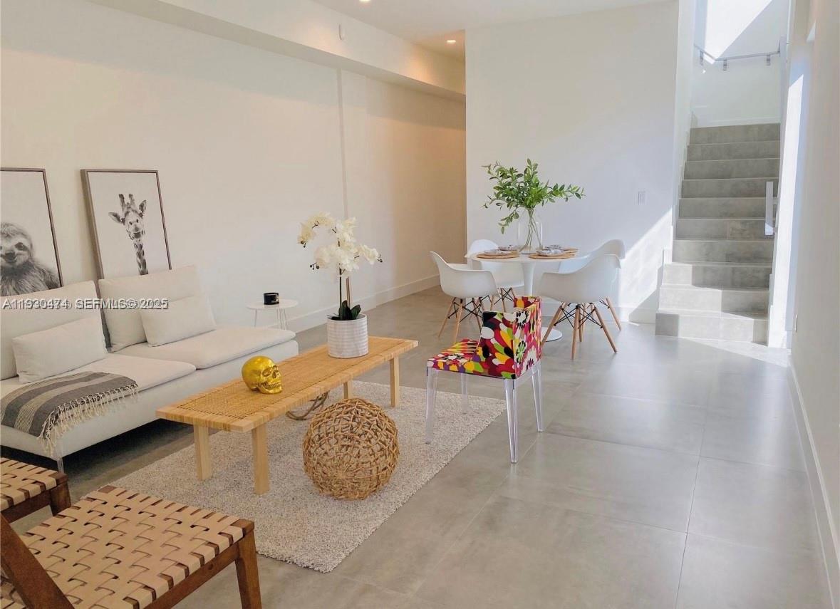 3653 Southwest 25th Street, Unit 3653 Miami, FL 33133 - Photo 3 of 20 a living room with furniture and a table