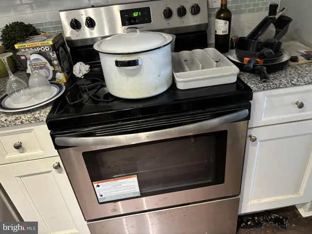 a stove top oven sitting inside of a kitchen