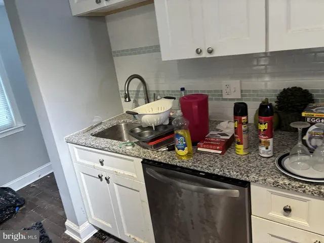 a kitchen with stainless steel appliances granite countertop a sink and cabinets