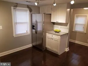 a kitchen with stainless steel appliances a refrigerator sink and microwave