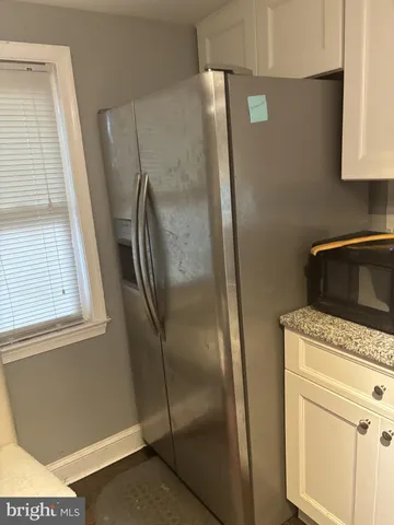 a kitchen with metallic refrigerator freezer and a dishwasher