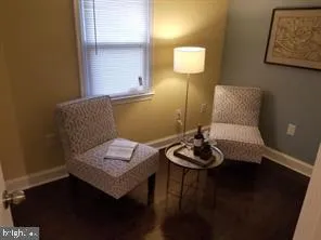 a living room with furniture and a lamp