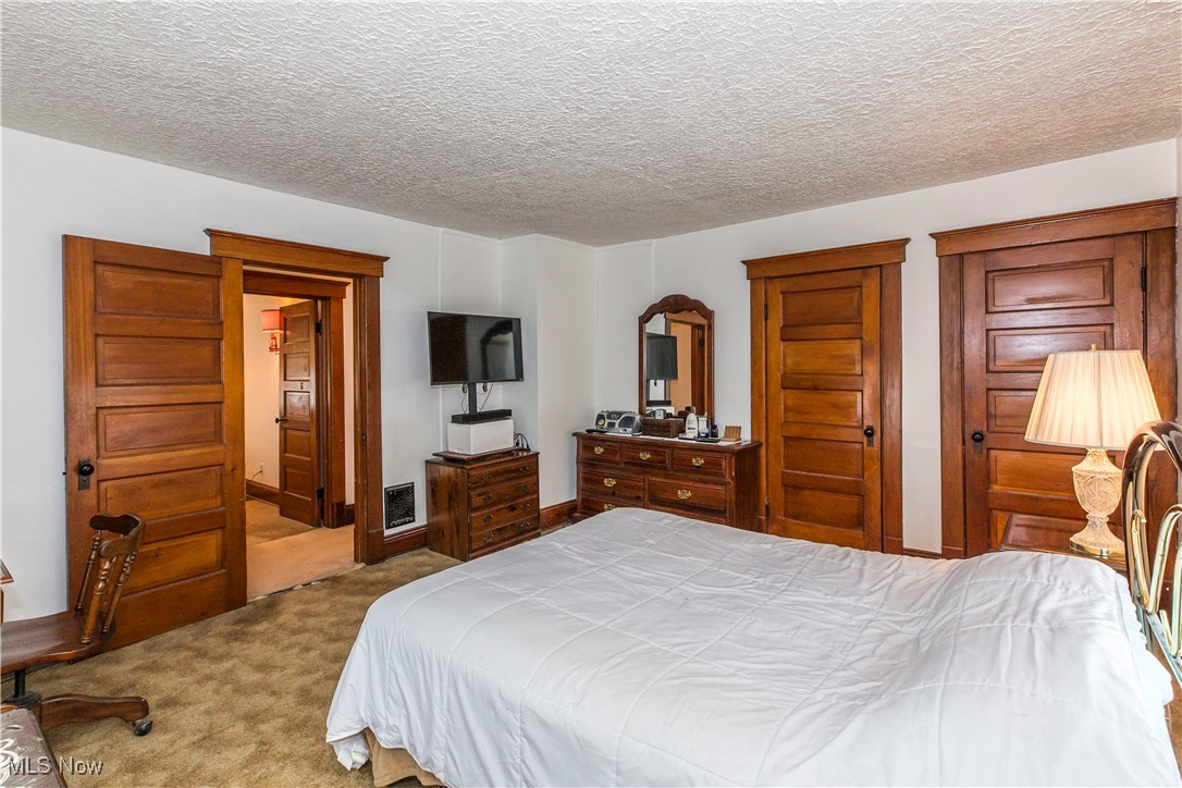 749 Amherst Road Northeast Massillon, OH 44646 - Photo 34 of 41 Bedroom with carpet flooring and a textured ceiling