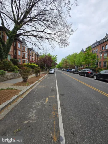 a view of street with parked cars