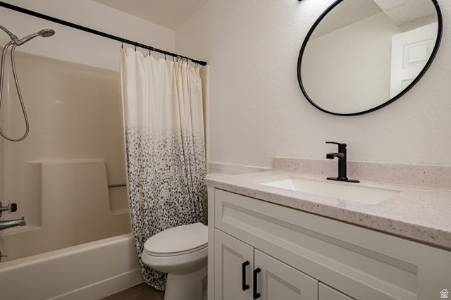 1221 Waterside Cove, Unit 11 Midvale, UT 84047 - Photo 15 of 23 Bathroom featuring a white vanity with shaker-style doors, black hardware, and a light-toned countertop