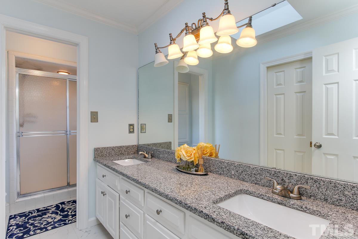 312 Dixie Trail Raleigh, NC 27607 - Photo 14 of 25 a bathroom with a granite countertop sink and a mirror