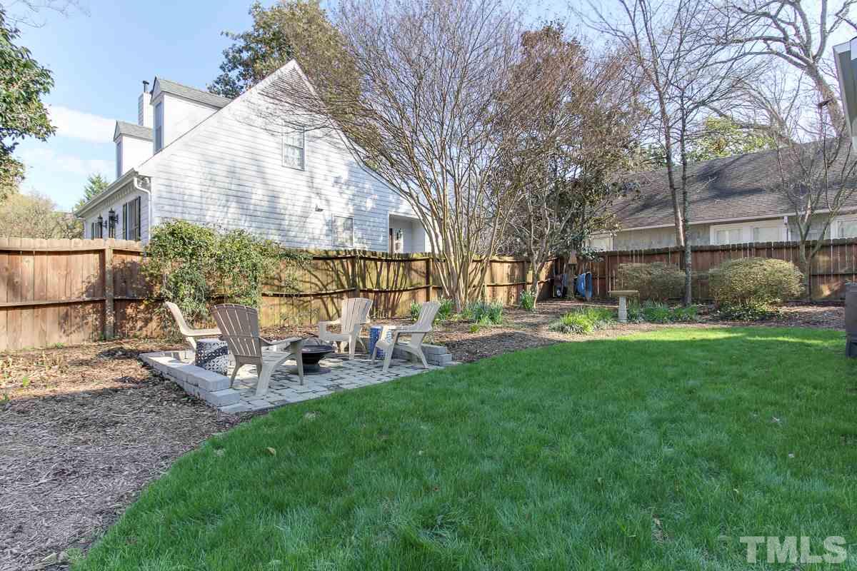 312 Dixie Trail Raleigh, NC 27607 - Photo 21 of 25 a view of backyard with table and chairs and wooden fence