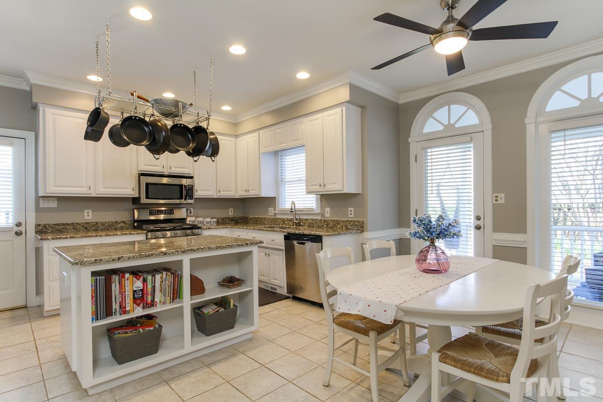 312 Dixie Trail Raleigh, NC 27607 - Photo 5 of 25 a kitchen with a stove cabinets and window