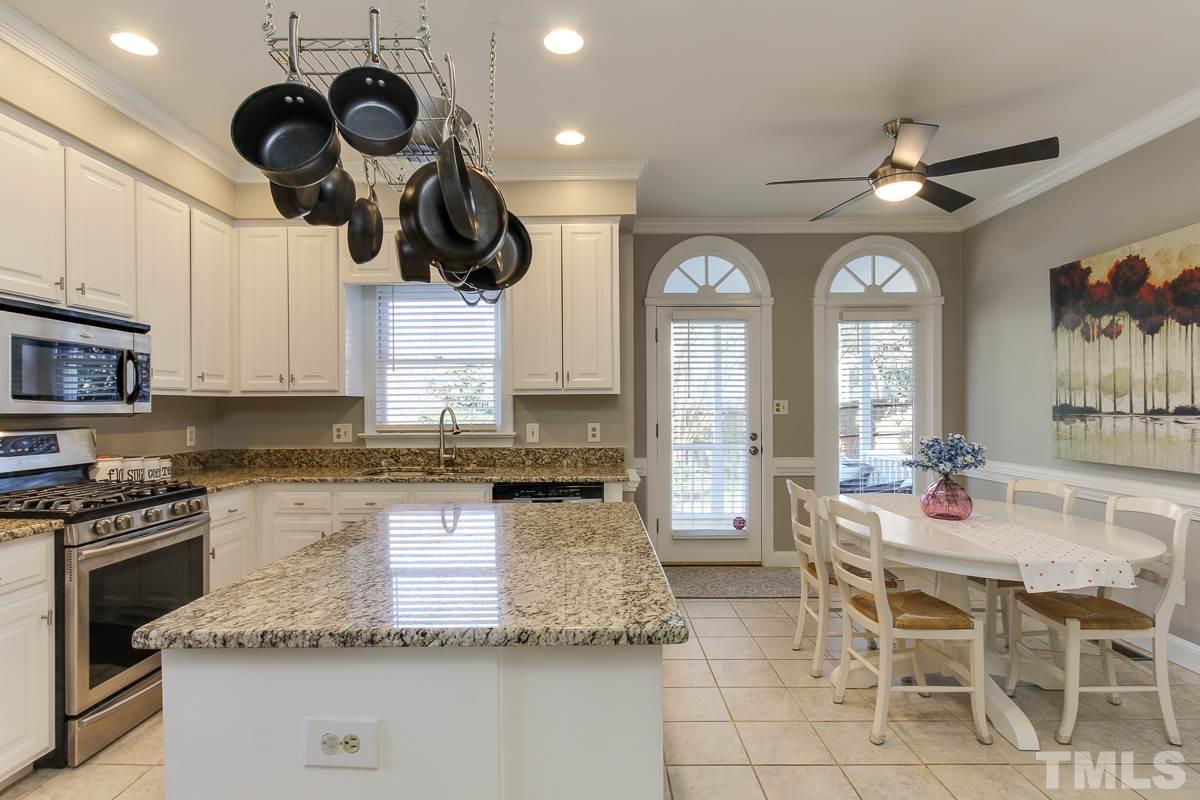 312 Dixie Trail Raleigh, NC 27607 - Photo 8 of 25 a kitchen with stainless steel appliances granite countertop a sink a stove and a wooden floors