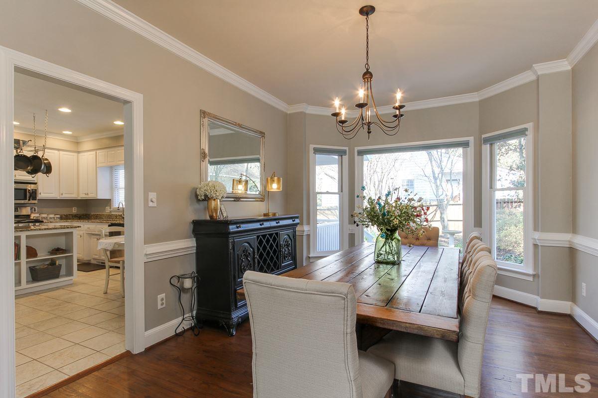 312 Dixie Trail Raleigh, NC 27607 - Photo 9 of 25 a view of a dining room and livingroom with furniture wooden floor a chandelier