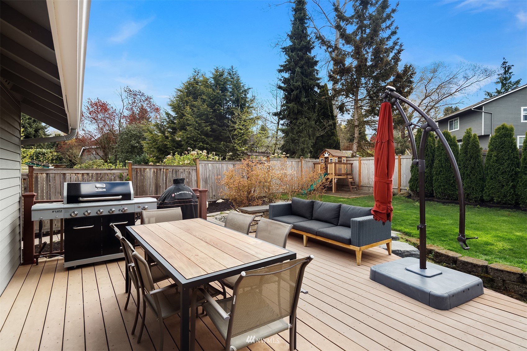 1920 233rd Place Southeast Bothell, WA 98021 - Photo 26 of 29 a view of a patio with couches table and chairs with wooden floor and fence