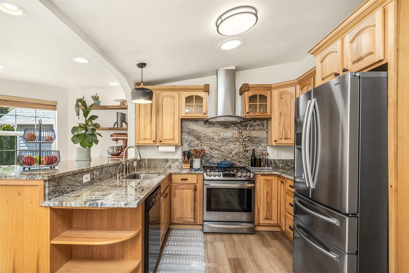 1920 233rd Place Southeast Bothell, WA 98021 - Photo 5 of 29 a kitchen with stainless steel appliances granite countertop a sink stove and refrigerator