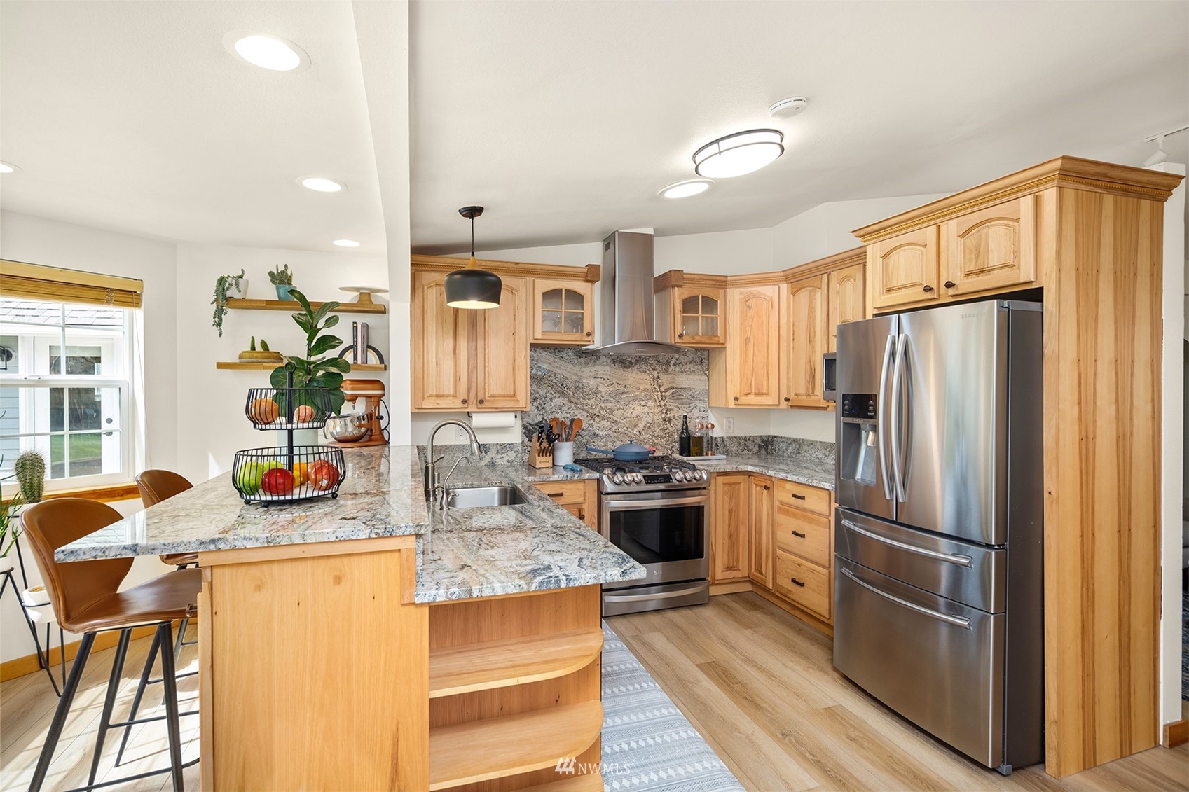 1920 233rd Place Southeast Bothell, WA 98021 - Photo 6 of 29 a kitchen with stainless steel appliances granite countertop a refrigerator a stove and a sink with cabinets