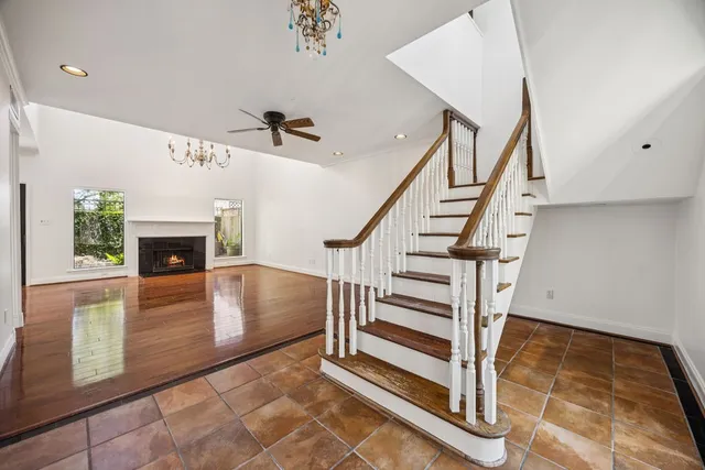 a view of a room with wooden floor staircase and a kitchen