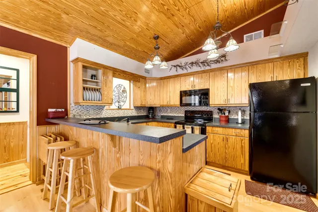 a large kitchen with a large counter top appliances and cabinets