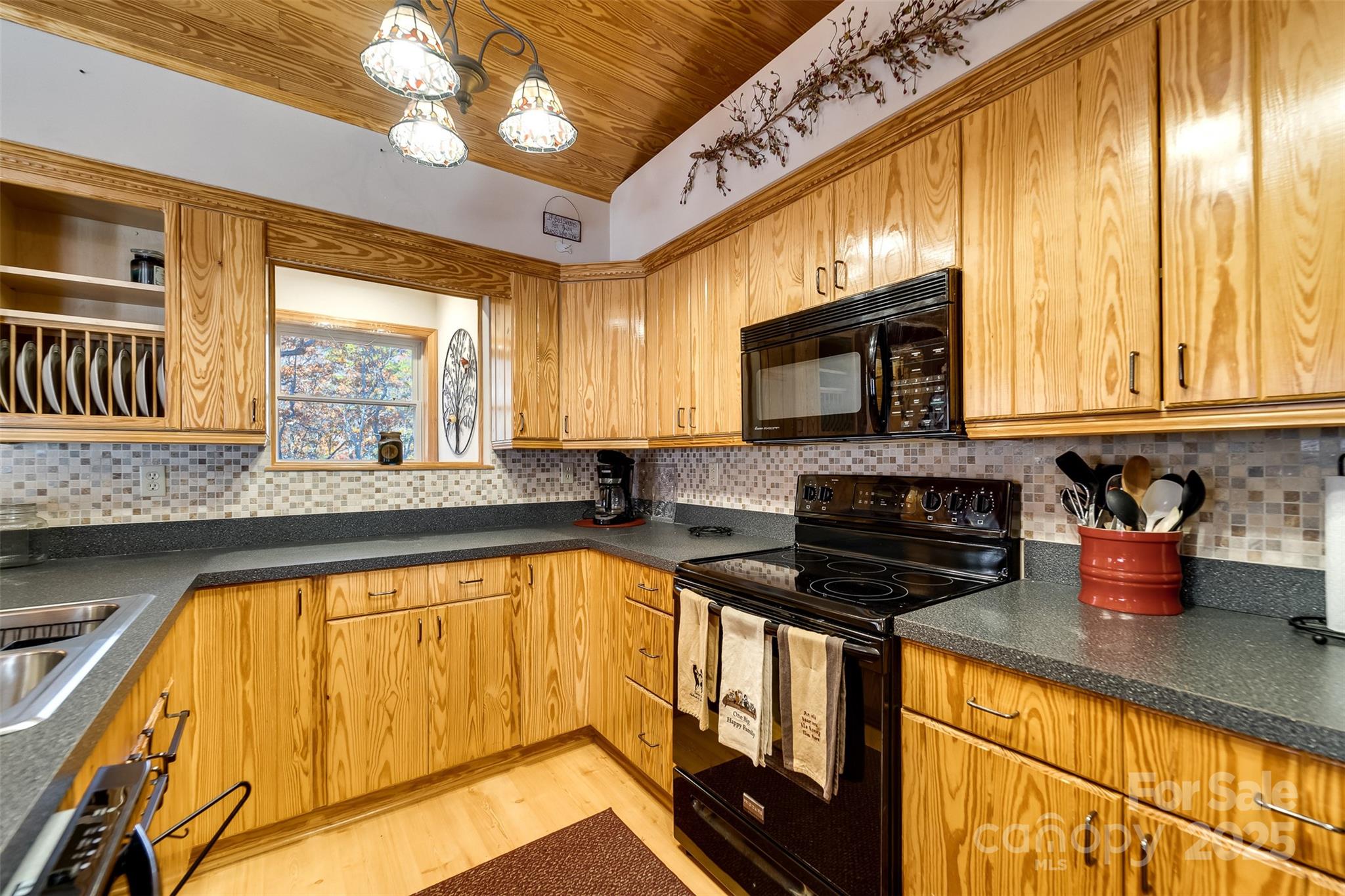 2311 Alarka Road Bryson City, NC 28713 - Photo 15 of 47 a kitchen with a stove a sink and a microwave