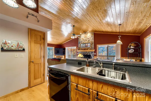 a kitchen with stainless steel appliances granite countertop a sink and cabinets