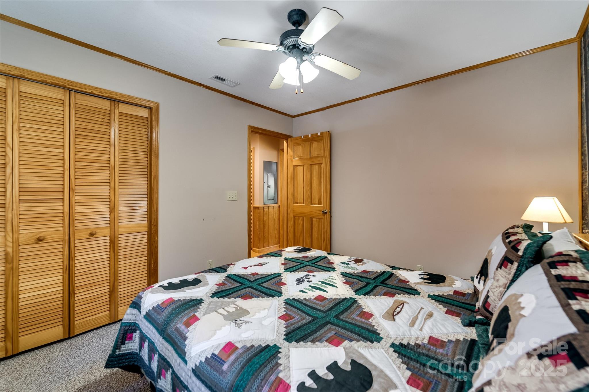 2311 Alarka Road Bryson City, NC 28713 - Photo 19 of 47 a bedroom with a bed and a chandelier