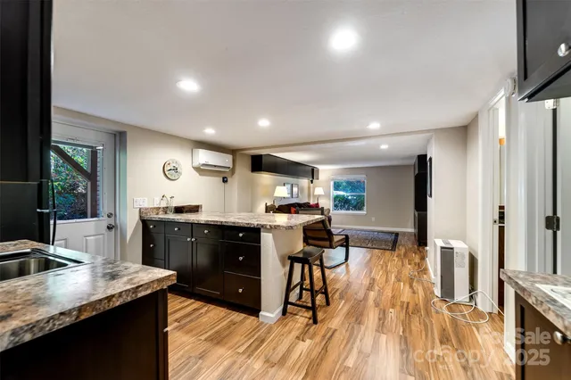 a kitchen with stainless steel appliances granite countertop sink stove top oven and cabinets