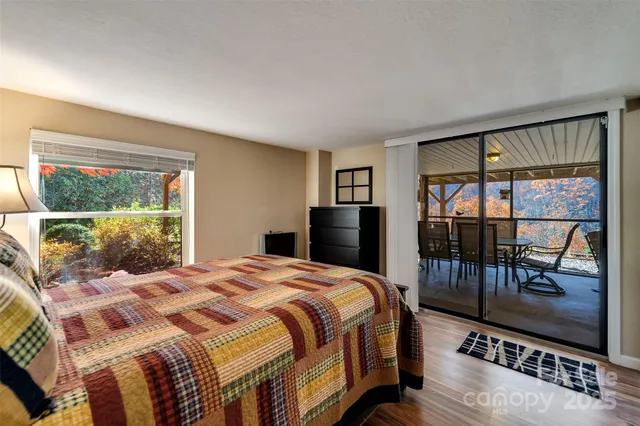 a bedroom with a bed and glass window