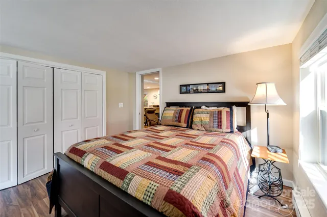 a bedroom with a bed and a painting