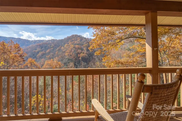 a view of a balcony with chair and wooden floor