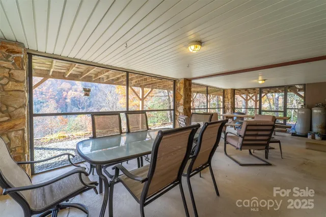 a dining room with furniture and a floor to ceiling window