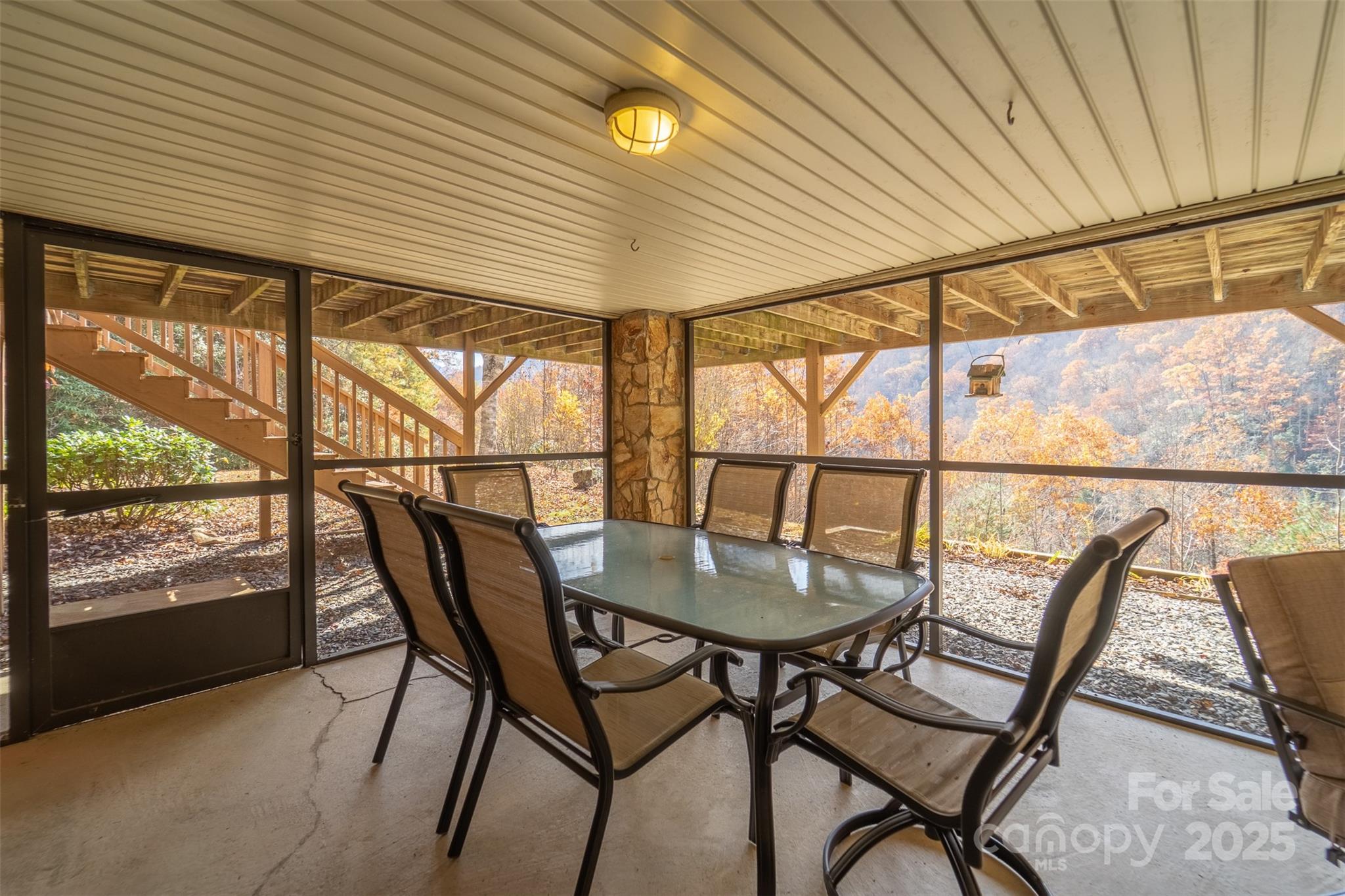 2311 Alarka Road Bryson City, NC 28713 - Photo 38 of 47 a dining room with furniture and a floor to ceiling window
