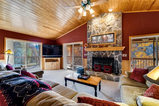 a living room with furniture fireplace and flat screen tv