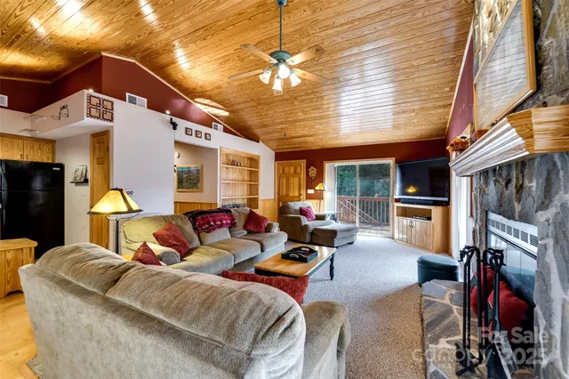 a living room with furniture a fireplace and a chandelier