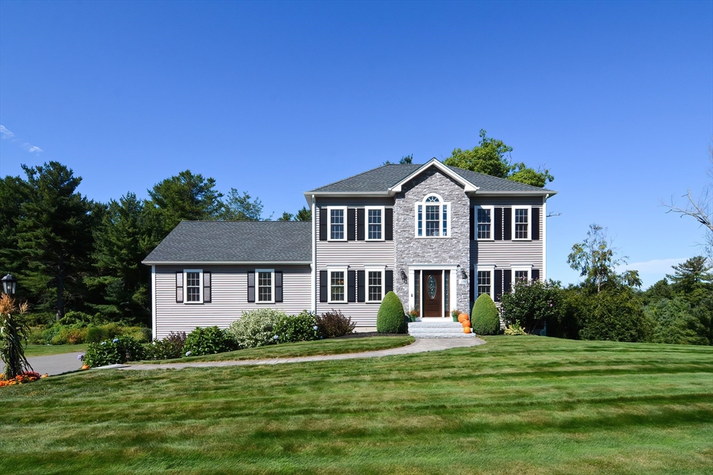 a front view of a house with a garden