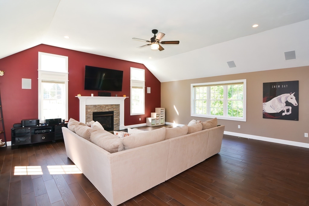 310 Main Street Rutland, MA 01543 - Photo 13 of 39 a living room with furniture a flat screen tv and a fireplace
