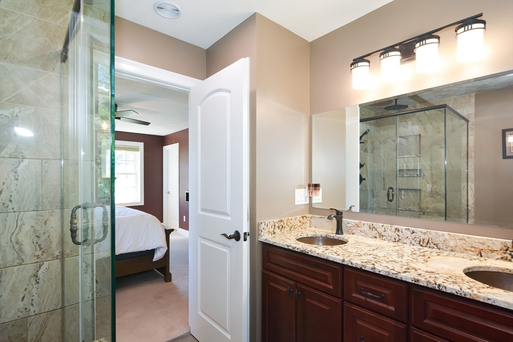 310 Main Street Rutland, MA 01543 - Photo 24 of 39 a en suite bathroom with a double vanity sink and mirror with shower