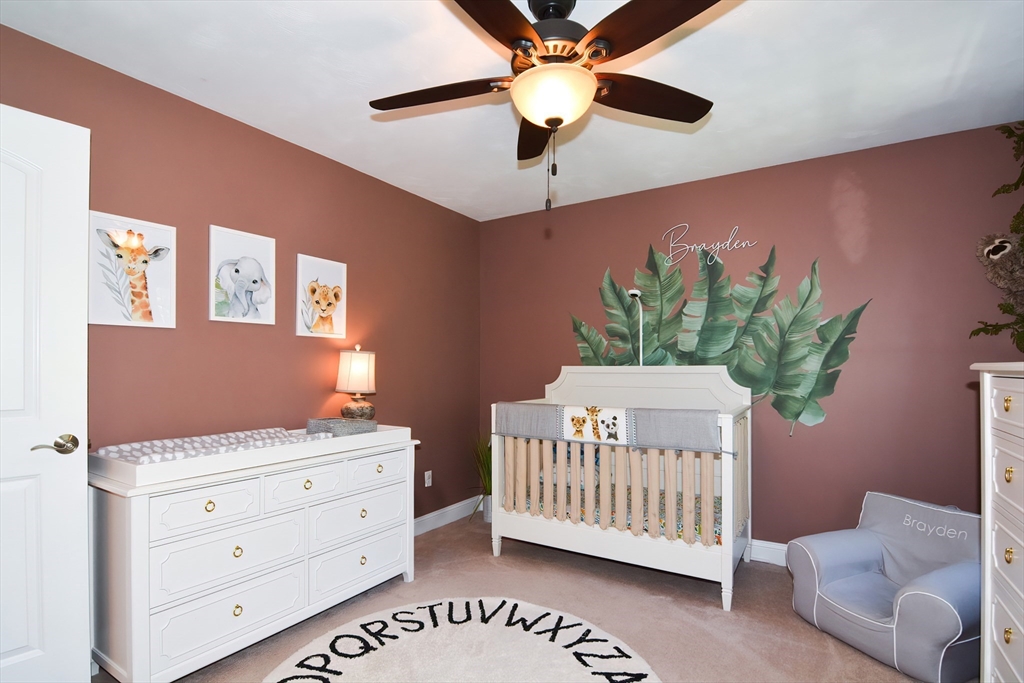 310 Main Street Rutland, MA 01543 - Photo 26 of 39 a bedroom with a bed and a chandelier