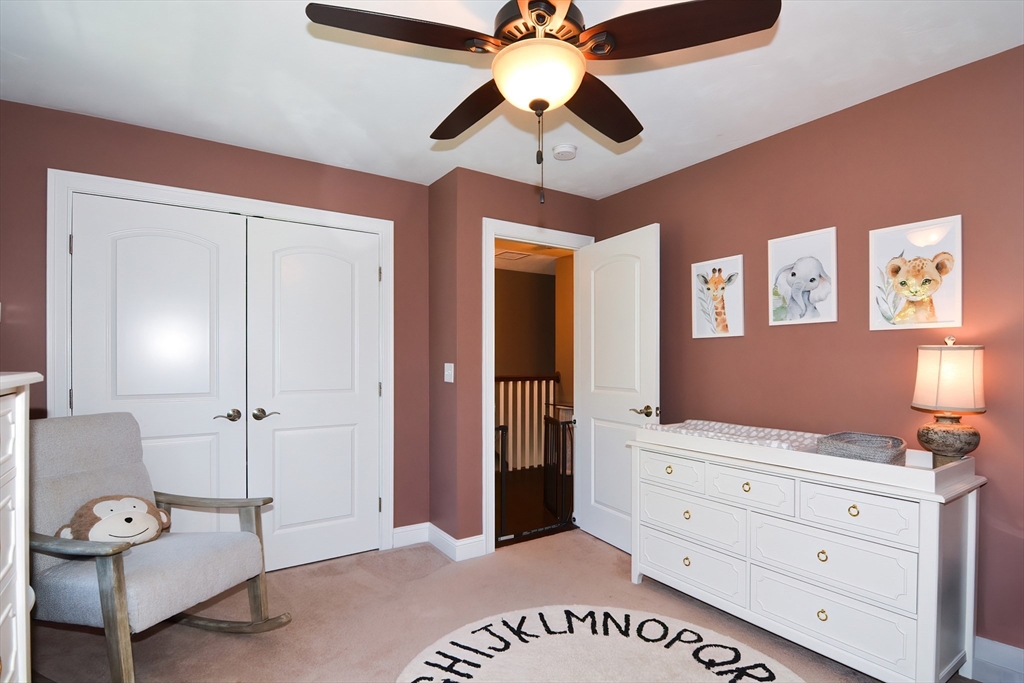 310 Main Street Rutland, MA 01543 - Photo 27 of 39 a spacious bedroom with a bed and a chandelier